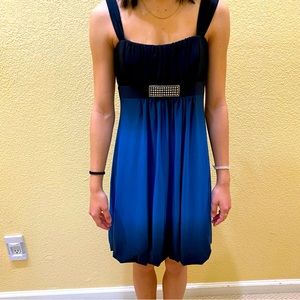 Cache two-toned dress with jewel.